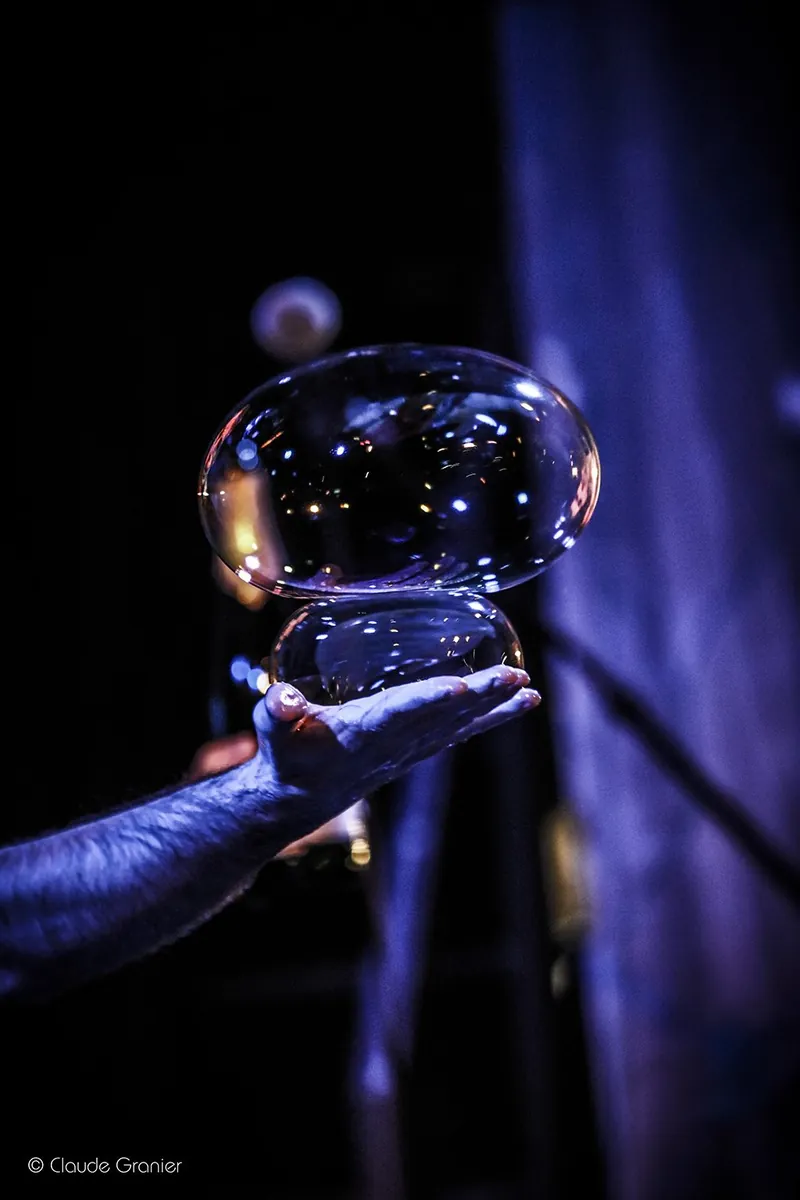 A double bubble resting above an open hand