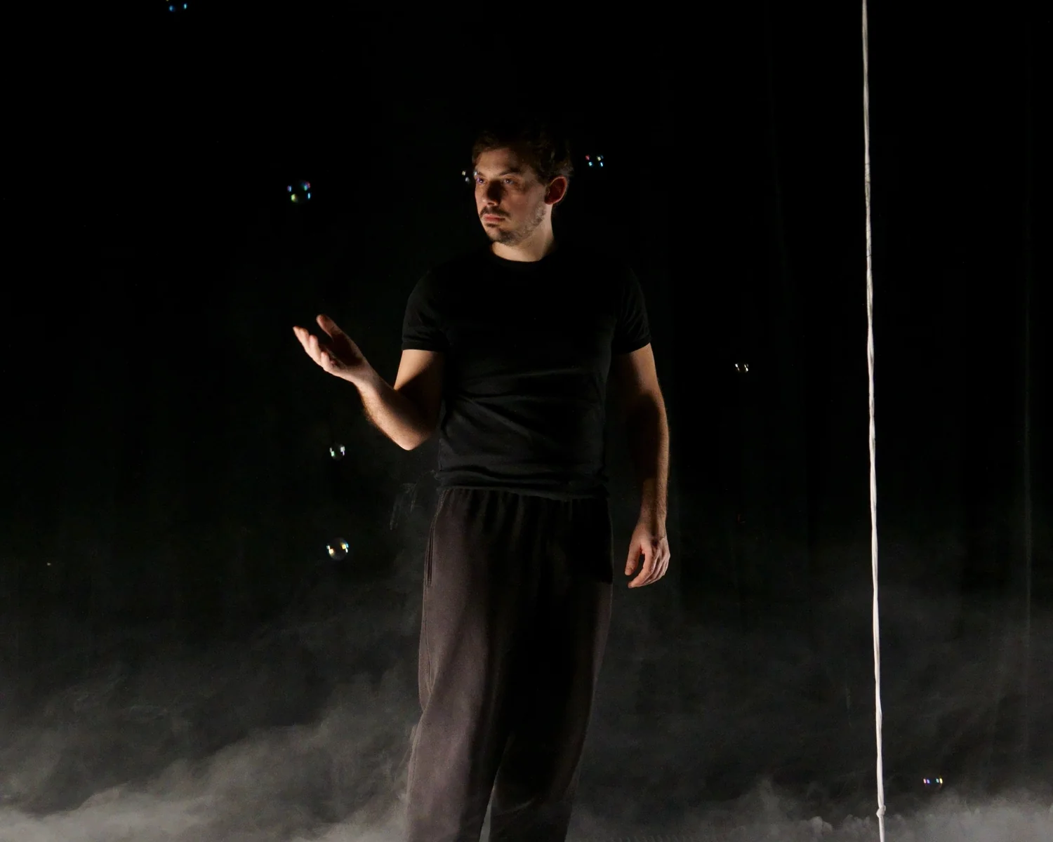 Vincent Wüthrich on stage, standing in smoke