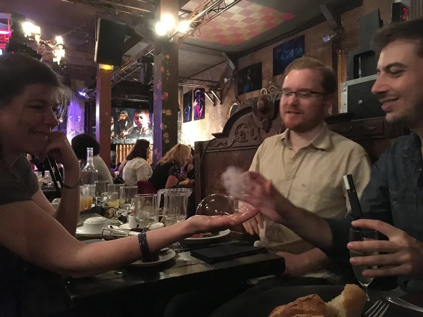 A bubble passes into a guest's hand at the table