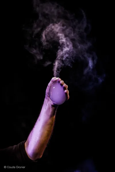 A smoke bubble resting in the crook of an outstretched arm