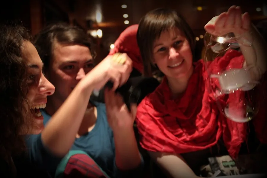Two guests laugh in front of a tower of bubbles