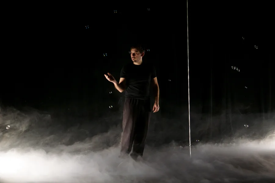 Vincent Wüthrich on stage, standing in smoke